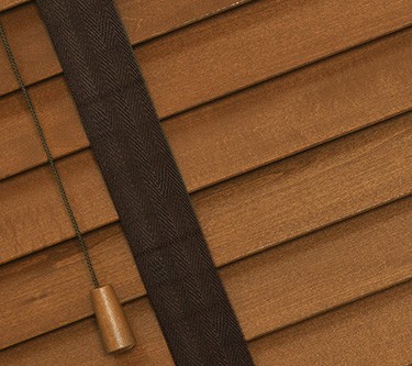 medium oak wooden venetian blinds with tapes close up